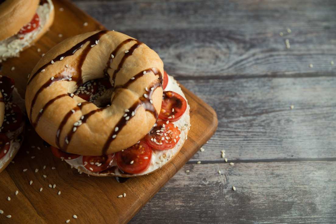 Food photography: seeded bagel on a wooden table